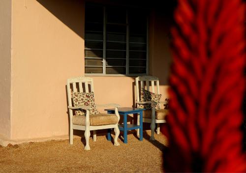two chairs and a table in front of a building at Fossil Hills in McGregor