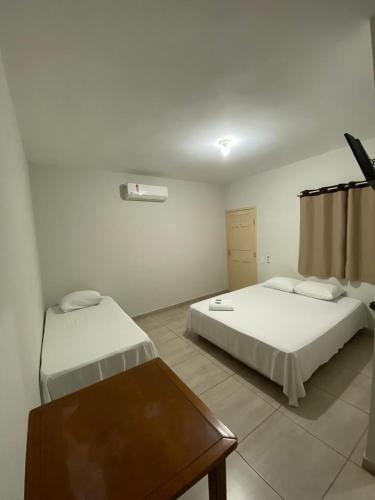 Ένα ή περισσότερα κρεβάτια σε δωμάτιο στο Hospedagem De Ferias