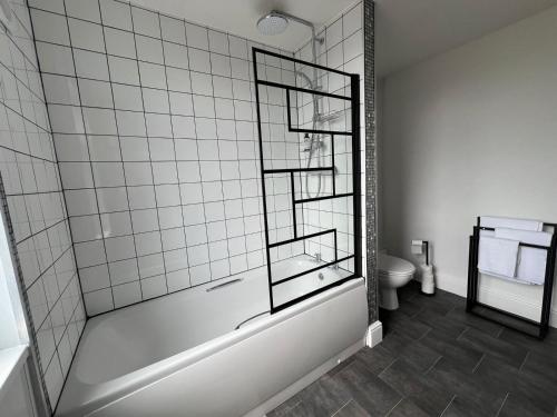 a bathroom with a bath tub and a toilet at Host & Stay - Regent Street in Kettering