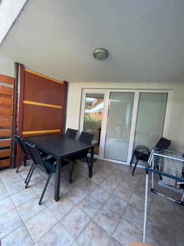 a dining room with a table and chairs on a patio at Apartma Ajda in Moravske Toplice