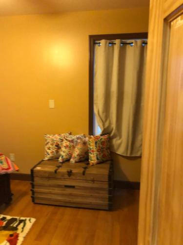 a couch with pillows on it in a room at Private Unit with own Entrance To Share in South Ozone Park