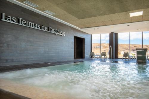 a large pool of water in a building at R2 Bahia Playa - Adults Only in Tarajalejo