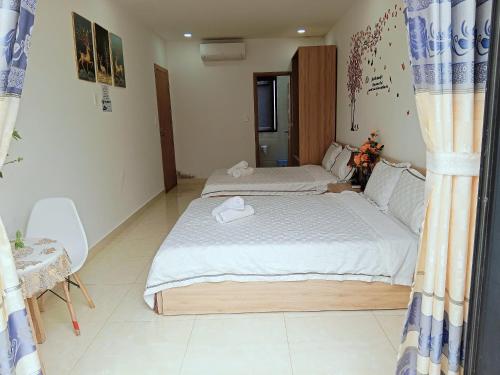 a bedroom with a bed with two towels on it at Thiên Ý Homestay in Phu Quoc