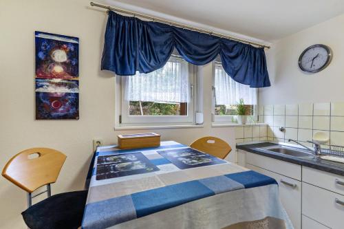 a kitchen with a blue and white table and chairs at Haus Rebberg in Wolfach
