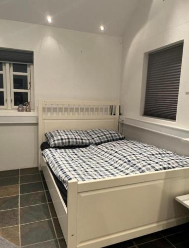 a white bed in a room with two windows at Auszeit im Grünen in Fårvang