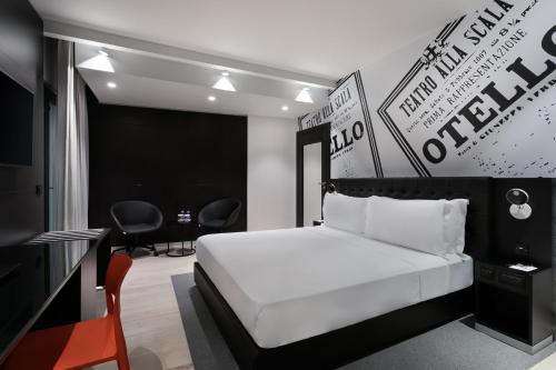 a bedroom with a bed and a table and chairs at Verdi Gzira Promenade in Sliema