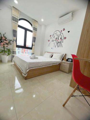 a bedroom with a bed with a drawing on the wall at Thiên Ý Homestay in Phu Quoc