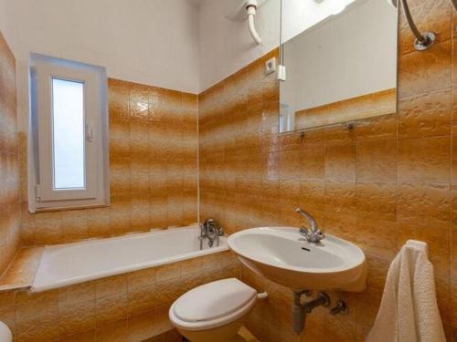 a bathroom with a sink and a toilet and a tub at Apartments Nena ST - Standard One Bedroom Apartment with Balcony and Sea View A2 in Pisak
