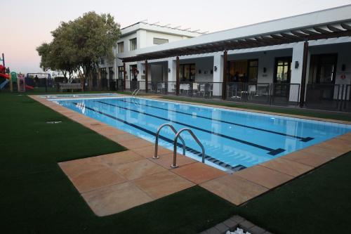 a large swimming pool in front of a building at LM company in Edendale