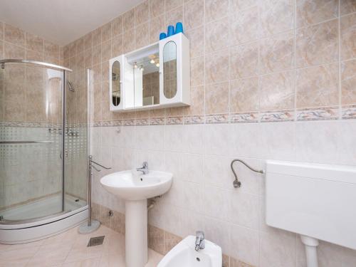 a bathroom with a sink and a toilet and a shower at Holiday Home Lido - Three Bedroom Holiday House with Terrace in Orebić
