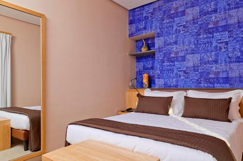 a bedroom with a bed and a mirror at Airone Hotel in Naples