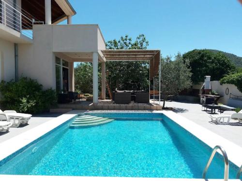 a swimming pool in the backyard of a house at Apartments Villa Dona -Two Bedroom Apartment with Shared Swimming Pool in Vela Luka