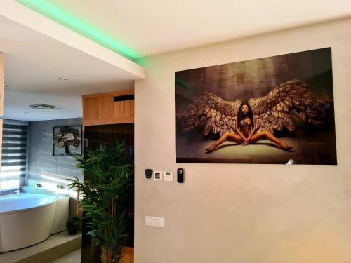 a bathroom with an angel painting on the wall at Wellness Apartments - Studio Apartment with Terrace G3 in Varaždin