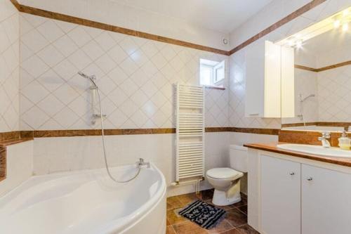 a bathroom with a tub and a toilet and a sink at Apartment Blue Oasis - Three Bedroom Apartment ST in Postira