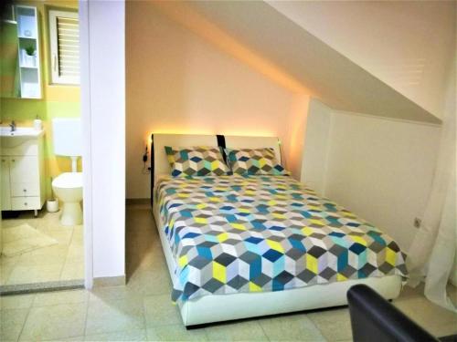 a bedroom with a bed and a bathroom at Apartments Milic - Studio Apartment with Sea View 4 - 2 in Gornji Karin