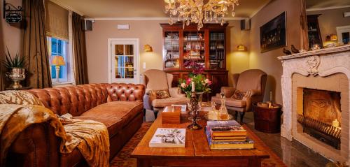 a living room with a couch and a fireplace at Villa Reynaert in Opoeteren