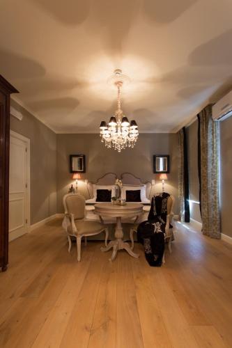 a dining room with a table and chairs and a chandelier at Villa Reynaert in Opoeteren