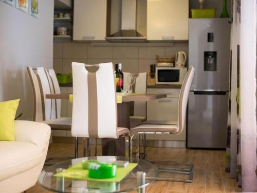 a kitchen with a couch and a table with chairs at Holiday Home Belmondo- Three Bedroom Home with Terrace and Private Pool A6 in Gruda