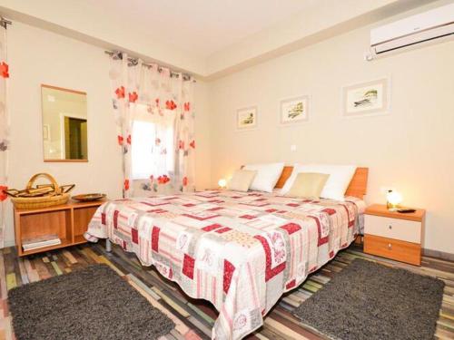 a bedroom with a large bed and a window at Holiday Home Belmondo- Three Bedroom Home with Terrace and Private Pool A6 in Gruda
