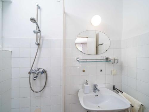 a white bathroom with a shower and a sink at Apartments Zarac - One Bedroom Apartment with Balcony and Sea View Milanka in Zaton
