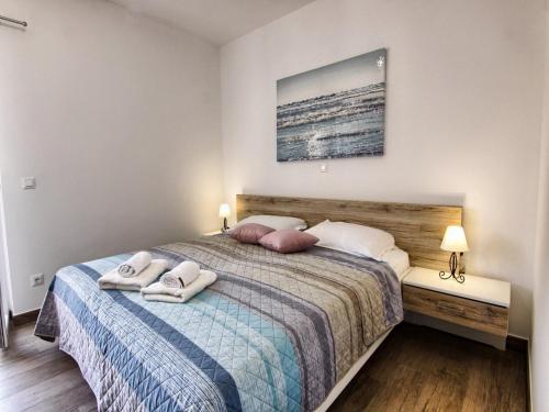 a bedroom with a bed with two towels on it at Apartments Victoria - One Bedroom Apartment with Terrace A2 in Pakoštane