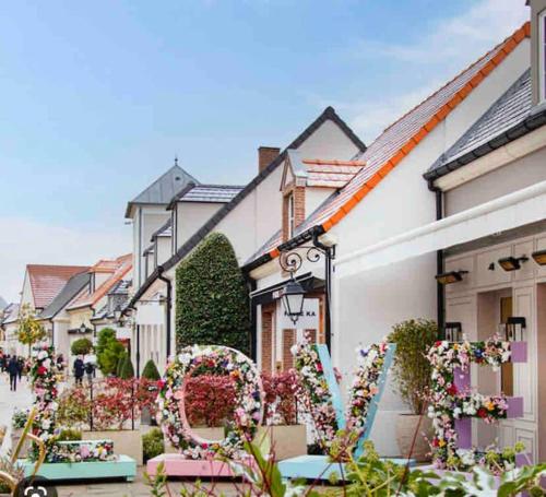 a row of houses with a heart made of flowers at Disney en famille&Appart Calme et Spacieux in Magny-le-Hongre