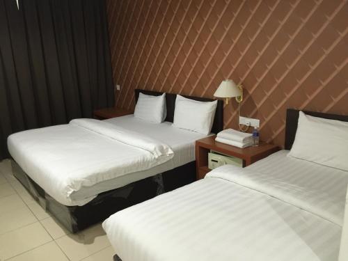 Postel nebo postele na pokoji v ubytování Permai Hotel
