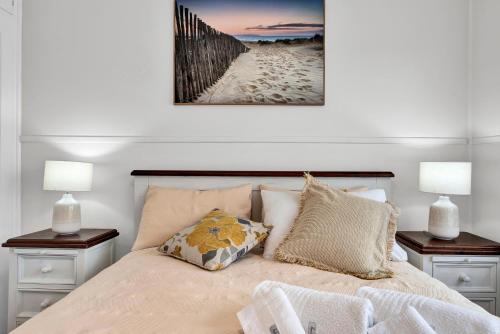 a bedroom with a bed with two night stands and two lamps at Long Island Beach House gateway to Mornington Peninsula#Free parking in Frankston