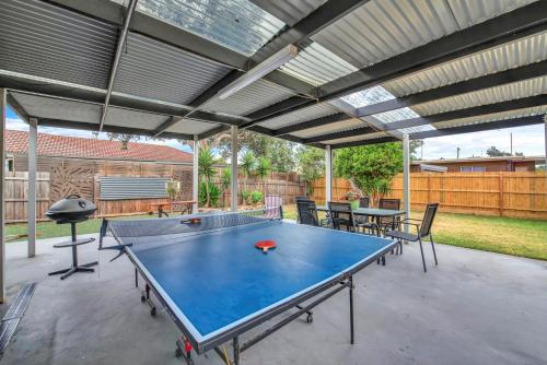 a ping pong table in the middle of a patio at Long Island Beach House gateway to Mornington Peninsula#Free parking in Frankston