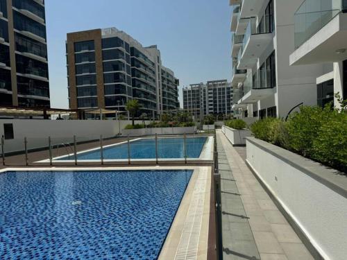a swimming pool on the side of a building at Stunning Studio in Meydan Azizi 42 in Dubai