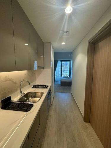 a kitchen with a sink and a counter top at Stunning Studio in Meydan Azizi 42 in Dubai