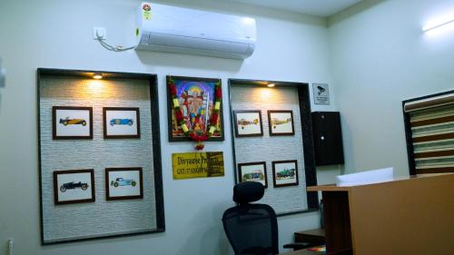 a room with a wall with pictures on the wall at Divya Comforts- 2BHK in Tirupati
