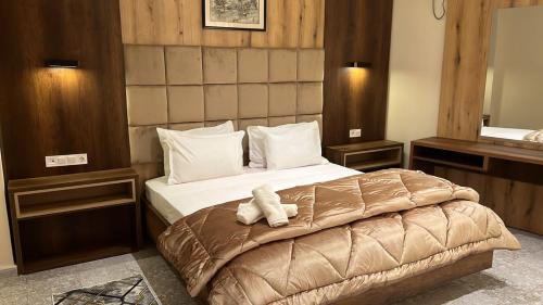 a bedroom with a bed with a stuffed animal on it at Hotel MEDINA in Oran