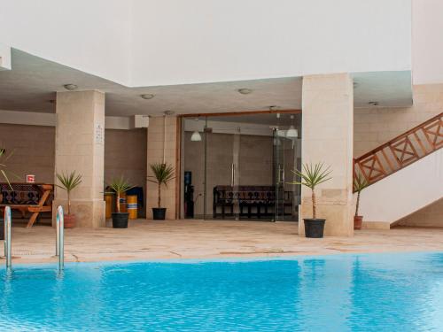 a large swimming pool in front of a building at Blue Vision Diving Hotel in Marsa Alam City