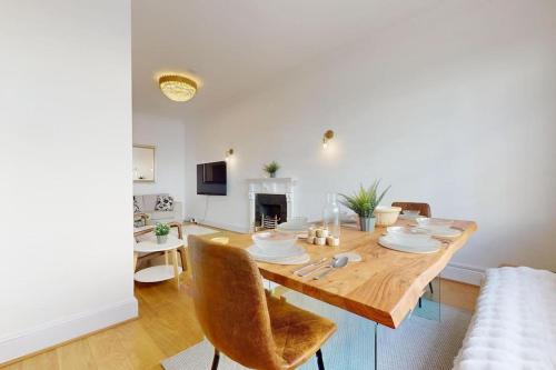 a dining table and chairs in a living room at Prime Location Prince's Gate Mews 4BD 3 BATH in London