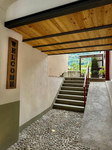 a staircase in a building with a wooden ceiling at Casa Armida in Tirano