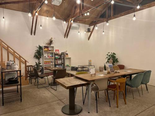 a dining room with wooden tables and chairs at HATAYA - Guesthouse - Private Stay - in Kyotango