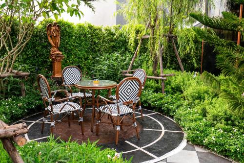 a group of chairs and a table in a garden at The One Smart Living in Bangkok