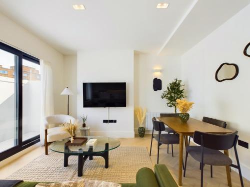 a living room with a couch and a table at Be London - Maida Vale Residences in London
