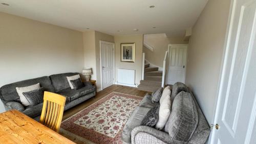 a living room with a couch and a table at 19 Snowdon Apartment in Stirling
