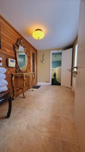 a room with a mirror on the wall and a table at Riverview Georgian House in Donaghmore Bridge
