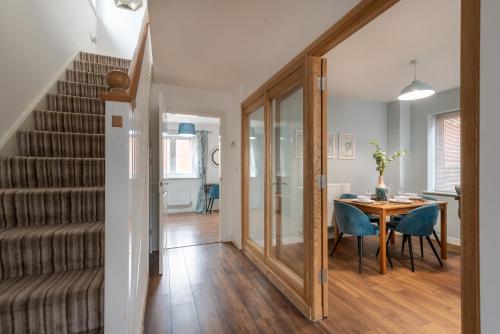 a hallway with a table and chairs and a staircase at Prime location 3 bed House in Newport