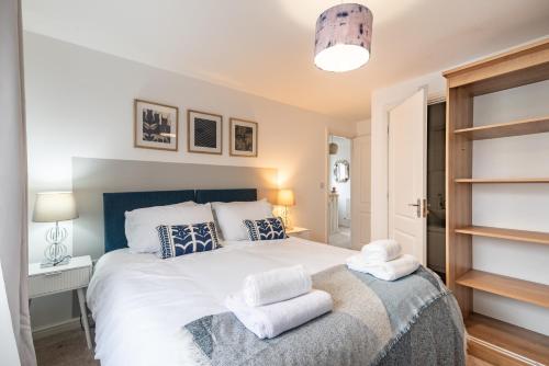 a bedroom with a bed with towels on it at Prime location 3 bed House in Newport