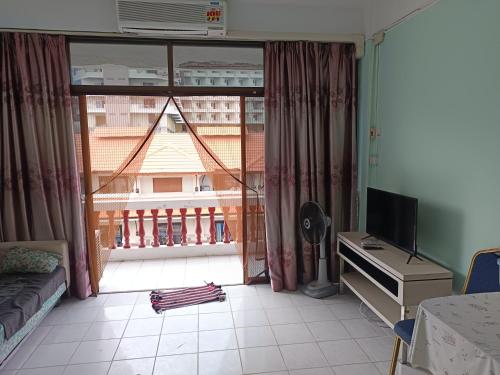 a living room with a large window and a television at SV. HOUSE in Jomtien Beach