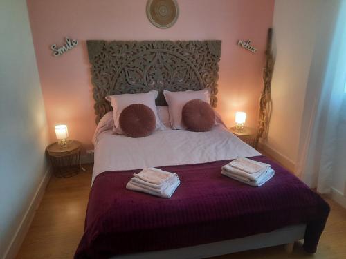 a bedroom with a bed with towels on it at GITE CHEZ MONETTE in Nance