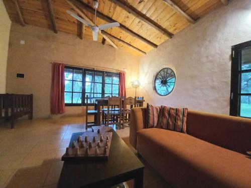 a living room with a couch and a chessboard on a table at Casa de campo parque Iberá in Colonia Carlos Pellegrini