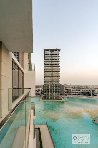 a swimming pool on the roof of a building at 2 Bed Apt in District One Dubai - Lagoon Views in Dubai