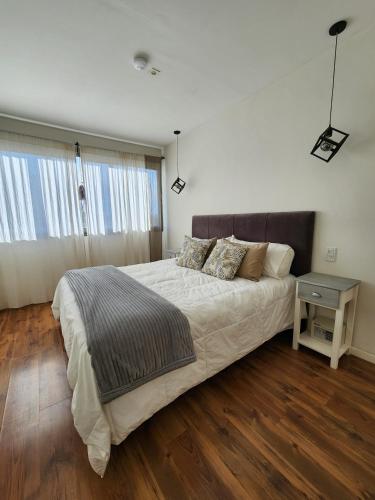 a bedroom with a large bed and a table at Olivos de Terrada in Ciudad Lujan de Cuyo