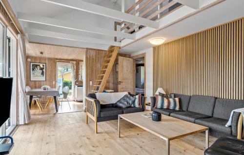a living room with a couch and a table at Awesome Home In Hejls With Sauna in Hejls