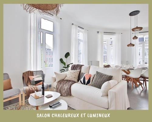a living room with a white couch and a table at La bulle bohème - Entièrement neuf, près de Spa in Verviers